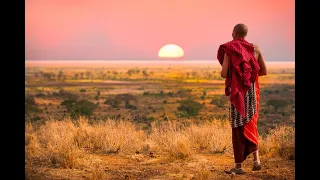 Maasai person overlooking East African savannah